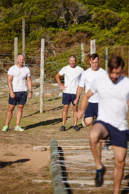 Buy stock photo Shot of a group of men doing drills at a military bootcamp