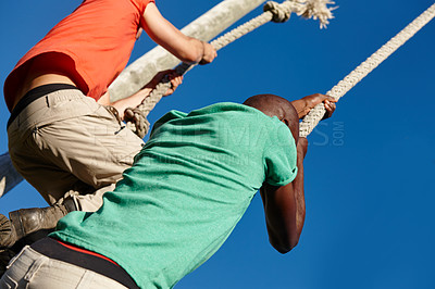 Buy stock photo Shot of two men climbing up ropes at bootcamp