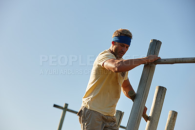 Buy stock photo Shot of a man going through an obstacle course at a military bootcamp