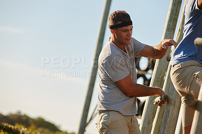 Buy stock photo Shot of men going through an obstacle course at bootcamp