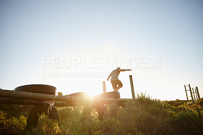Buy stock photo Full length shot of a man going through an obstacle course at bootcamp