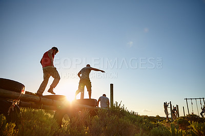 Buy stock photo Shot of men going through an obstacle course at bootcamp
