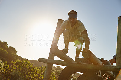 Buy stock photo Shot of a man going through an obstacle course at a military bootcamp