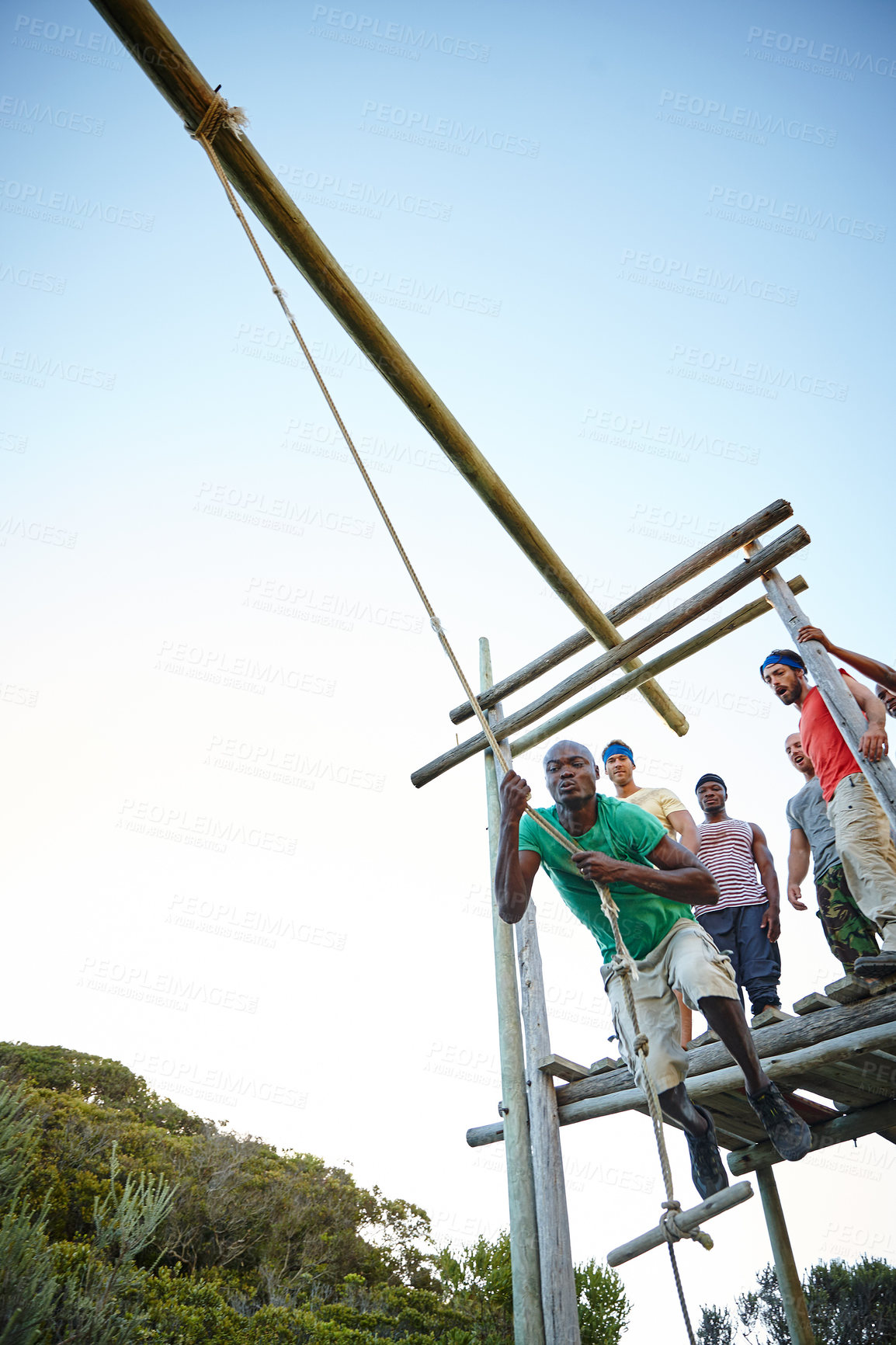 Buy stock photo Shot of a group of men going through an obstacle course at bootcamp