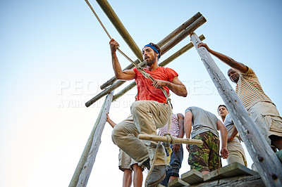 Buy stock photo Shot of a group of men going through an obstacle course at bootcamp