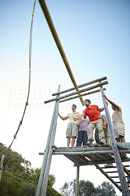 Buy stock photo Shot of a group of men going through an obstacle course at bootcamp