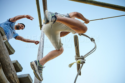 Buy stock photo Shot of young men going through an obstacle course at bootcamp