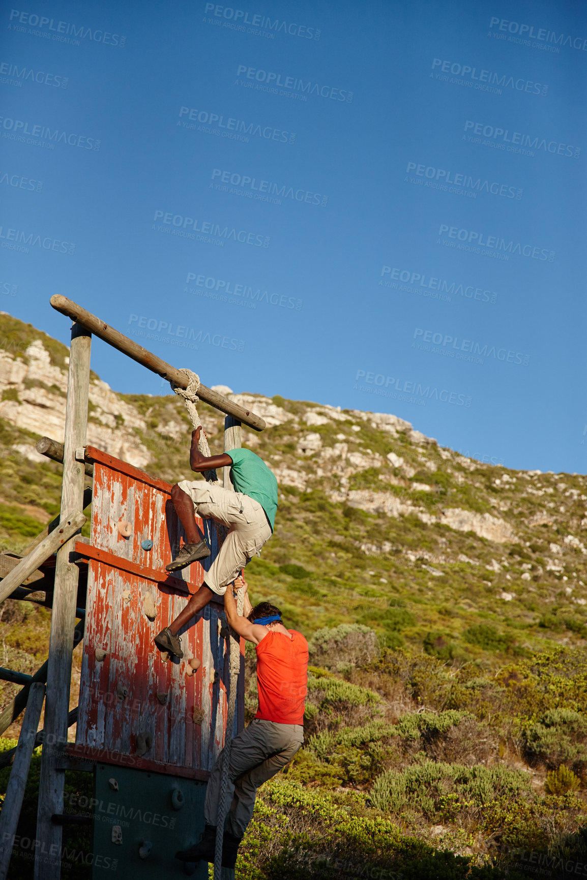 Buy stock photo Shot of a group of men going through an obstacle course at bootcamp