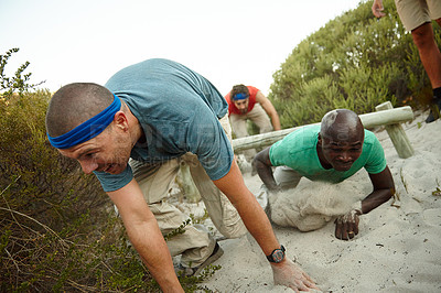 Buy stock photo Shot of a group of men going through an obstacle course at bootcamp