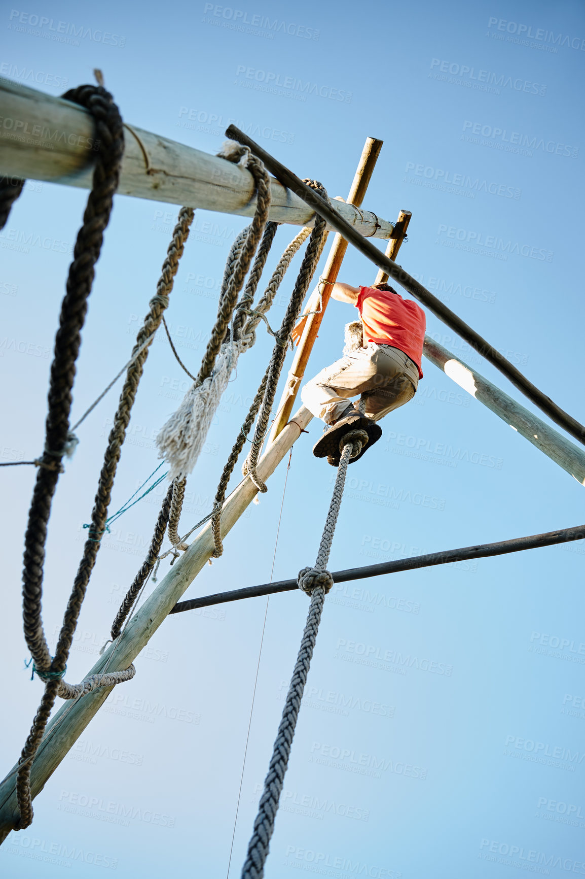 Buy stock photo Shot of a man climbing over an obstacle at bootcamp