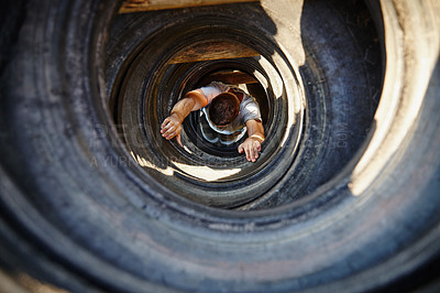 Buy stock photo Athlete, man and crawl with obstacle outdoor for strength training, military practice and mobility. Above, person and tire course for exercise challenge, fitness workout and survival test at bootcamp