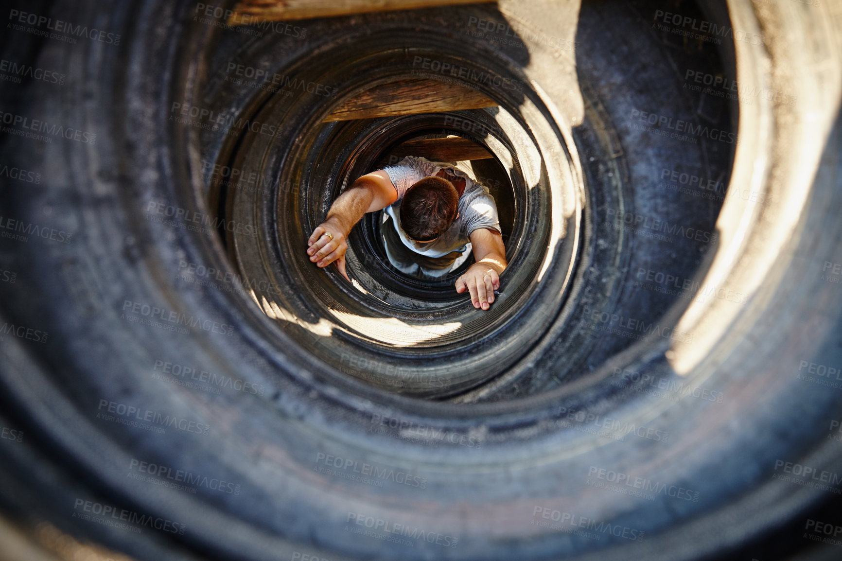 Buy stock photo Shot of a young man going through an obstacle at a military bootcamp