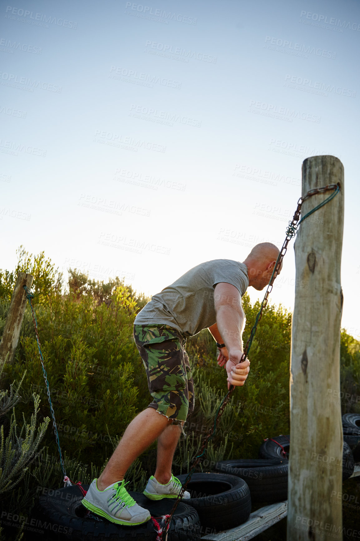 Buy stock photo Military, man and walk on obstacle outdoor for strength training, endurance and mobility development. Back, person and course exercise with balance challenge, survival assessment and bootcamp workout