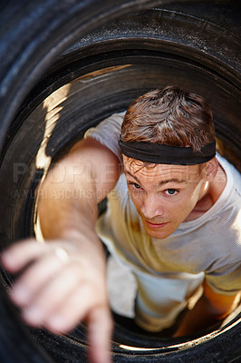 Buy stock photo Shot of a young man going through an obstacle at a military bootcamp