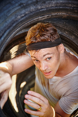 Buy stock photo Shot of a young man going through an obstacle at a military bootcamp