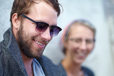 Buy stock photo Man, smile and fashion or sunglasses outdoors, trendy and urban or happy for style. Male person, outside and wall or accessory, cool and confident by backdrop, modern hipster and joy in downtown