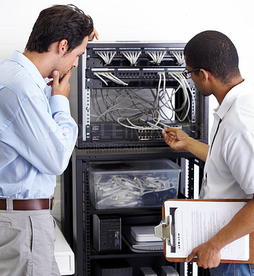 Buy stock photo Information technology, men and wire in server room for maintenance, inspection and fixing. Cable, IT technician and fix computer for cybersecurity, networking or database repair in data center.