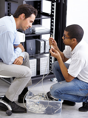 Buy stock photo Server room, man or electrician fixing cables for hardware maintenance or working on glitch in office. IT support, wire or worker with a technician or electrical engineer for information technology