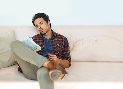 Buy stock photo Man, reading and relax with newspaper on couch in home, living room and learning about event or story in media, News, mockup and person with article in the paper on sofa in apartment with information