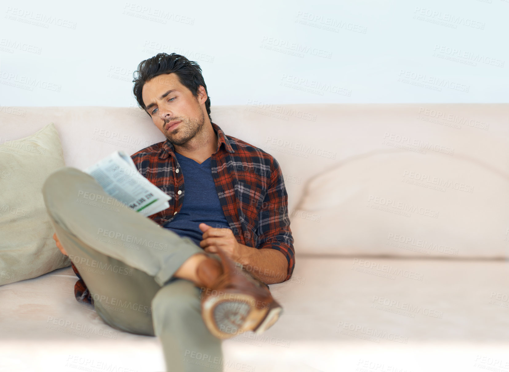 Buy stock photo Man, reading and relax with newspaper on couch in home, living room and learning about event or story in media, News, mockup and person with article in the paper on sofa in apartment with information