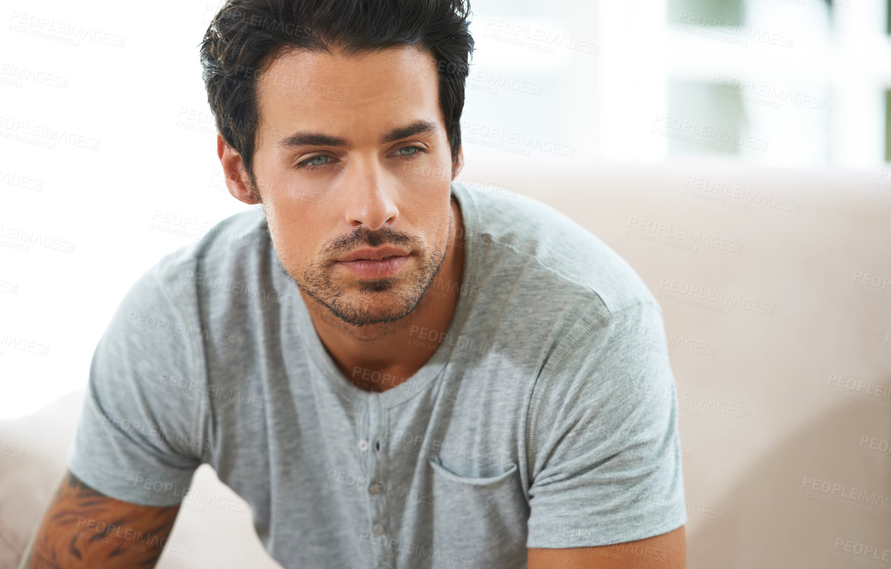 Buy stock photo Cropped shot of a handsome young man deep in thought
