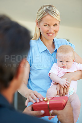 Buy stock photo Cropped shot of a man surprising his wife with a gift