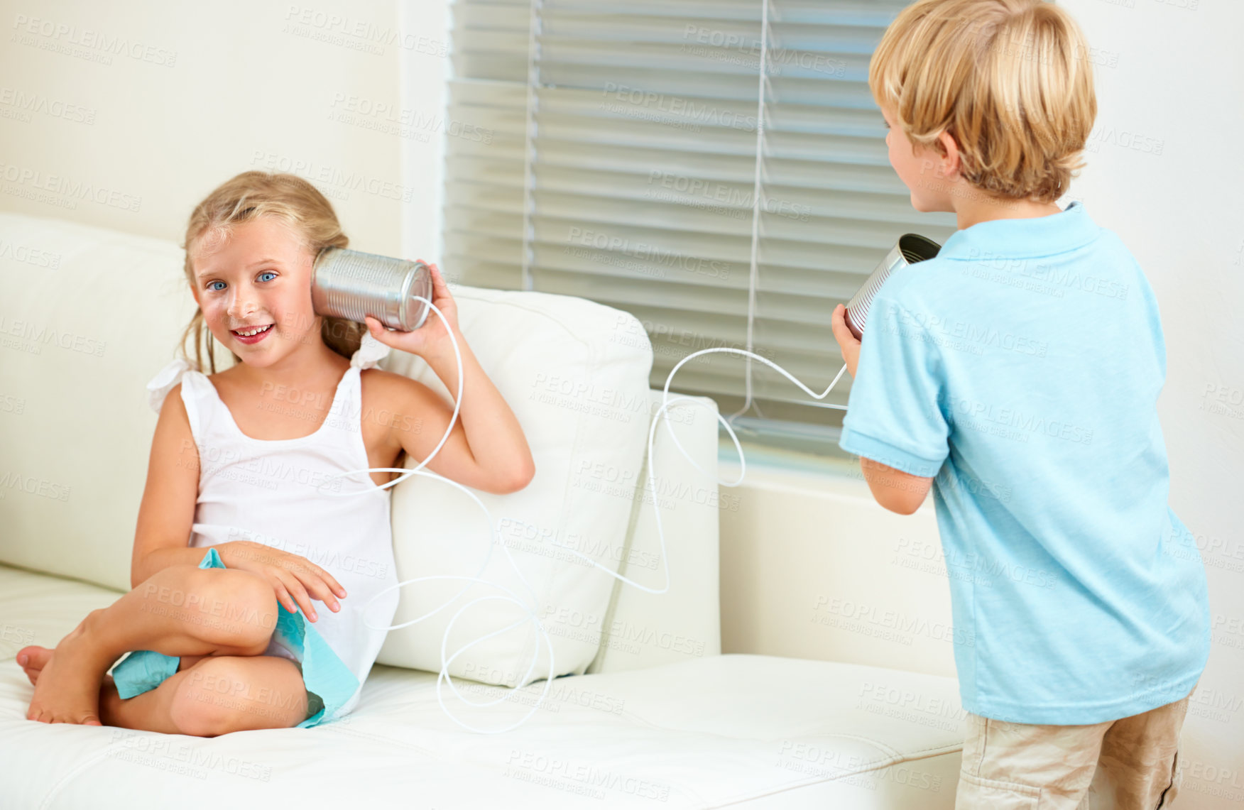 Buy stock photo Home, tin can and girl with boy, game and playing in the living room, happiness and fun on a couch. Apartment, siblings and children with weekend break, kids and relax with joy, smile or cheerful