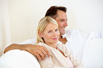 Buy stock photo Portrait, home and smile with couple on a couch, love and happiness with marriage, weekend break and cheerful. Joy, man and woman on sofa, bonding together or relationship with care, trust or support