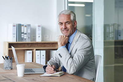 Buy stock photo Senior, businessman and smile, laptop and portrait at desk in the office for consultation. CEO, man and plan for budget, payroll and human resources and writing in company for startup proposal