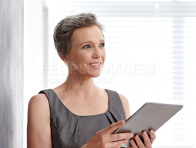 Buy stock photo A mature businesswoman looking thoughtful while holding her tablet