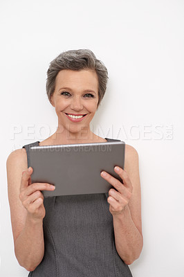 Buy stock photo Tablet, smile and portrait of businesswoman in studio for KPI reports, research or email communication. Happy, digital technology and mature female financial executive from London by white background