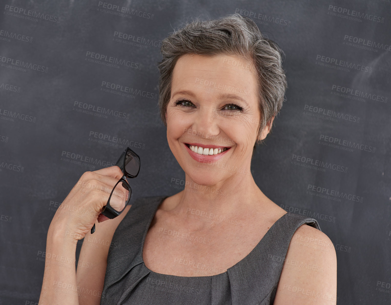 Buy stock photo Blackboard, glasses and portrait of teacher woman in classroom for development, education or lesson. Chalkboard, makeup and smile with happy mature person at school for growth, learning or teaching