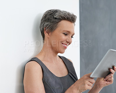 Buy stock photo Tablet, happy and mature business woman research app, reading email or check press release in startup. Digital technology, scroll and manager or creative public relations specialist on social media