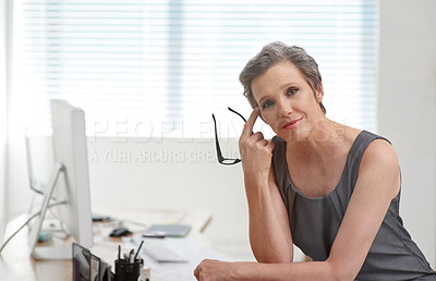 Buy stock photo Portrait of a confident mature businesswoman sitting in her office