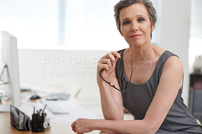 Buy stock photo Portrait of a confident mature businesswoman sitting in her office