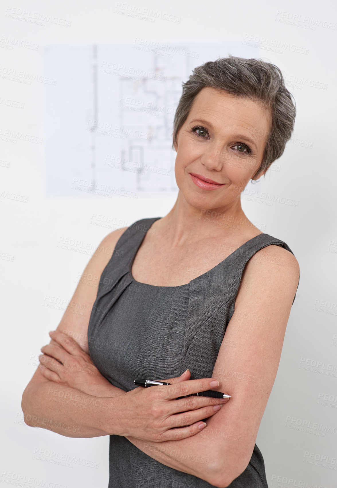 Buy stock photo Portrait, engineer and confident mature businesswoman in startup with blueprint on white wall. Face, professional architect and creative manager with arms crossed, designer and expert with pen in USA