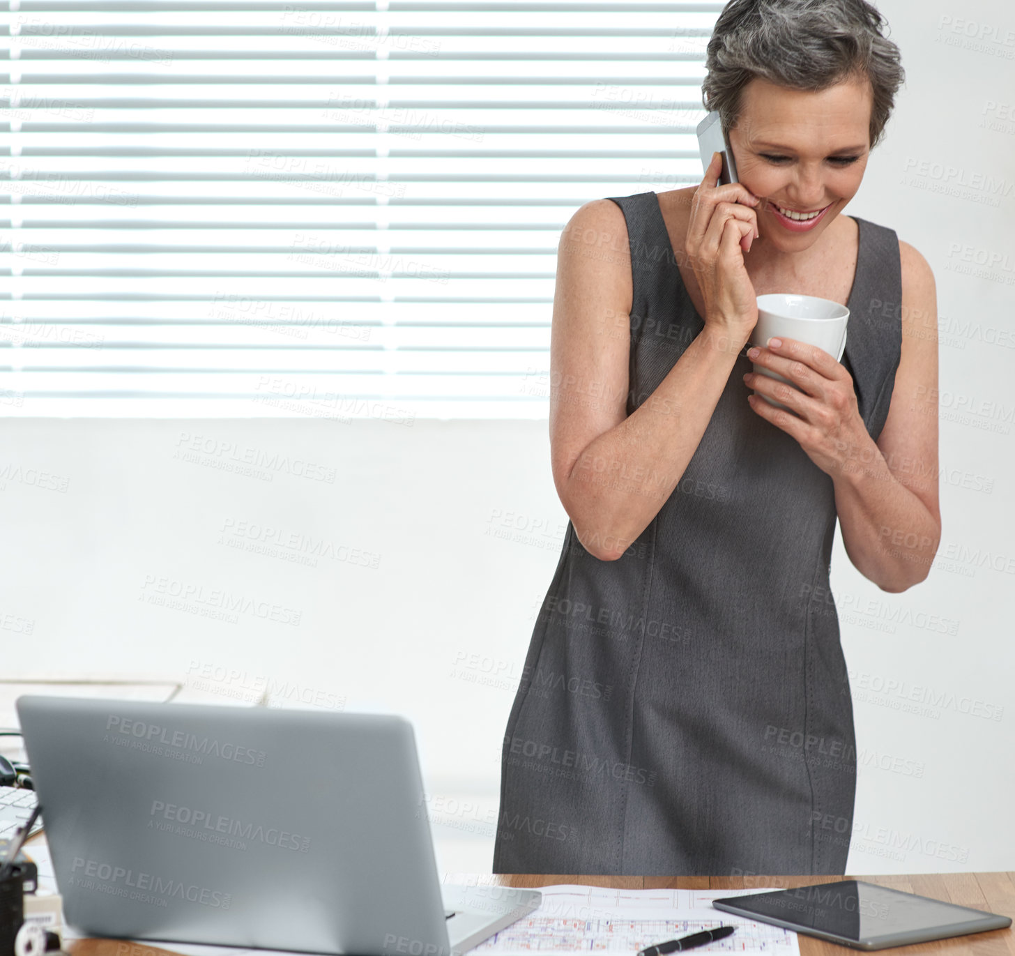 Buy stock photo Architect, thinking and phone call with smile, manager and research for creative partnership. Mature business woman, laptop and coffee break for document, brainstorming or problem solving in office