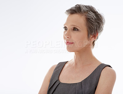 Buy stock photo A mature businesswoman looking away thoughtfully against a white background