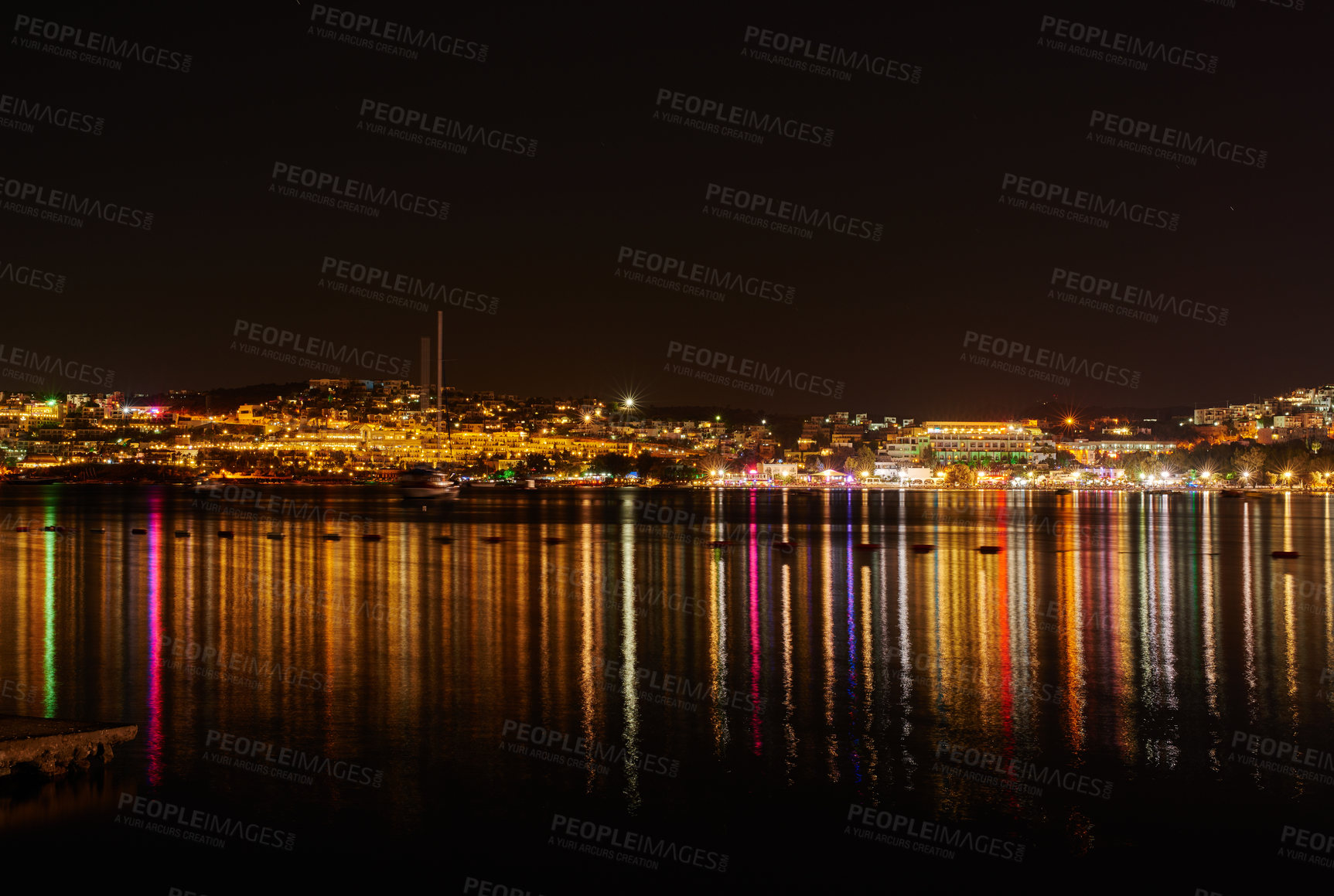 Buy stock photo City lights reflecting on water with dark sky copy space. River or lake at night with beach house light reflections on water surface. Colorful midnight skyscraper glowing in still water near a harbor