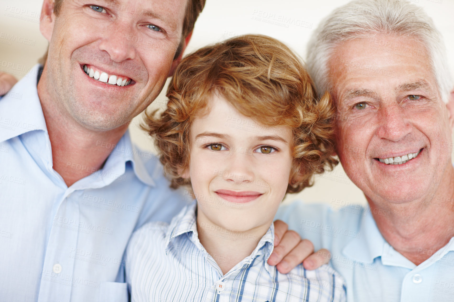 Buy stock photo Cropped portrait of a young boy standing with his father and grandfather
