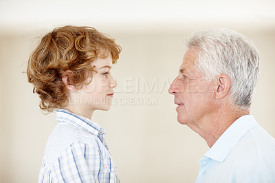 Buy stock photo Boy, grandpa and talking in home for bonding, looking and elderly person to help a kid with advice. Senior guy, grandson and speaking in lounge on weekend visit, love and conversation for family
