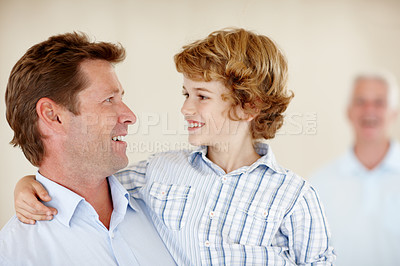 Buy stock photo Happy, hug and father and child in home together for bonding, relationship and fun with grandpa. Family, childhood and dad, young boy and grandfather embrace for love, support and relax on weekend