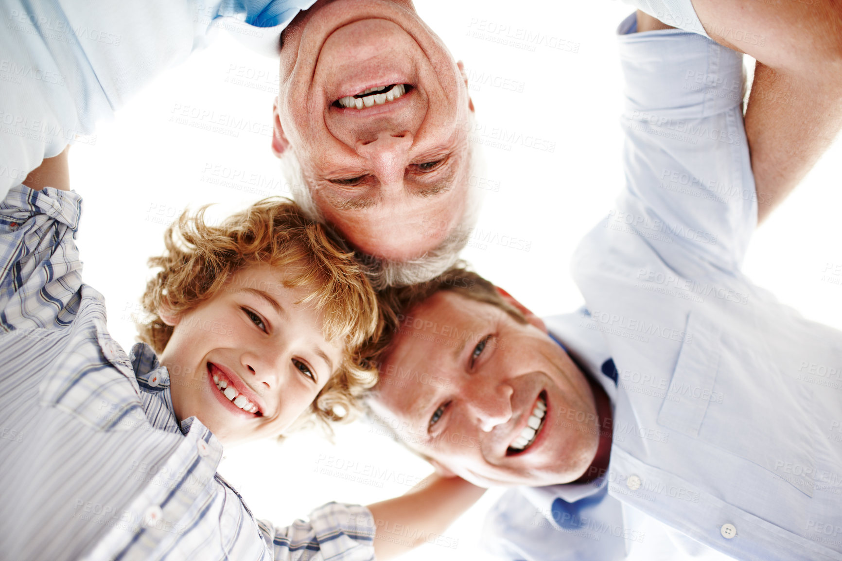 Buy stock photo Low angle portrait of a handsome man standing with his father and his son