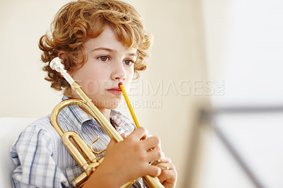 Buy stock photo Thinking, music sheet and child with trumpet for learning, musical lesson and practice for talent show. Musician, creative hobby and excited young boy with instrument, artist and notes to play song