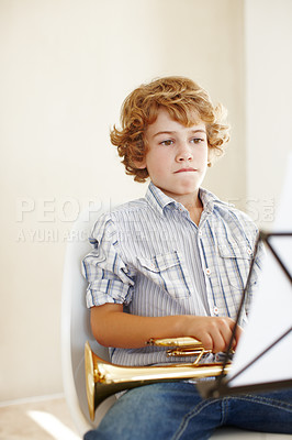 Buy stock photo Learning, music sheet and child with trumpet for practice, lesson and skills for talent show. Musician, creative hobby and young boy with musical instrument, paper and notes to play song or melody