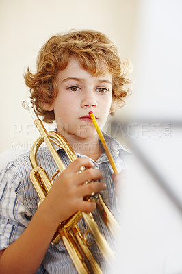 Buy stock photo Thinking, music and child with trumpet for practice, lesson and learning for talent show. Musician, creative hobby and young boy with musical instrument, paper and sheet notes to play song or melody