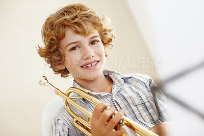 Buy stock photo Smile, music and portrait of child with trumpet for learning, orchestra lesson and practice for talent show. Musician, creative hobby and happy young boy with instrument, sheet and notes to play song
