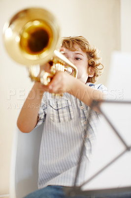 Buy stock photo Song, music and child with trumpet for playing, musical lesson and practice for talent show. Musician, creative hobby and young boy learning with instrument, sheet and notes to play jazz or melody