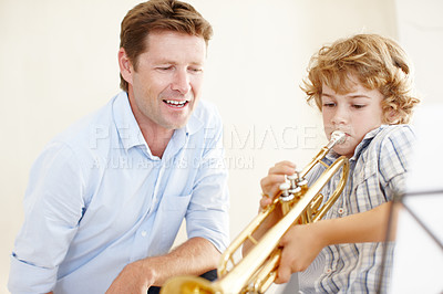 Buy stock photo Playing, music and teacher and child with trumpet for practice, lesson and skills for talent show. Learn, creative hobby and man with young boy with musical instrument, paper and notes to play song