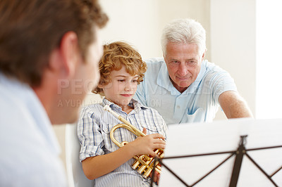 Buy stock photo Playing, music and grandpa and child with trumpet for practice, lesson and skills for talent show. Family, creative hobby and dad with young boy with learning instrument, paper and notes song at home